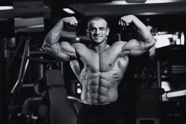 Athletic male performing controlled strength training in a modern gym